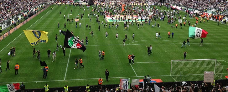 Cổ động viên Juventus cuồng nhiệt ăn mừng trên khán đài Curva Nord tại Allianz Stadium.